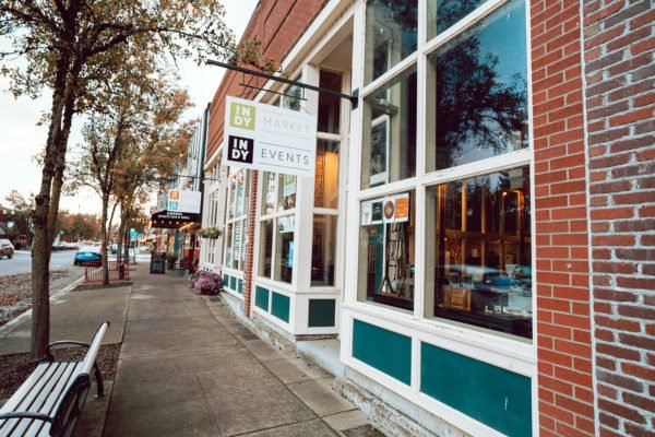 three people working together around a desk